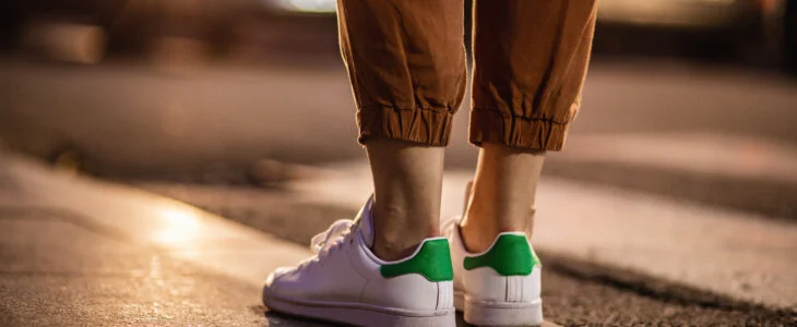 Woman's feet on the sidewalk as a car approaches