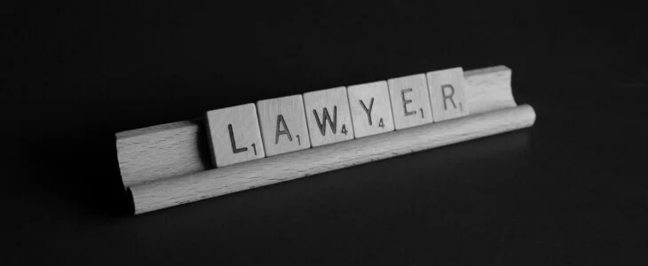 LAWYER spelled with Scrabble tiles.