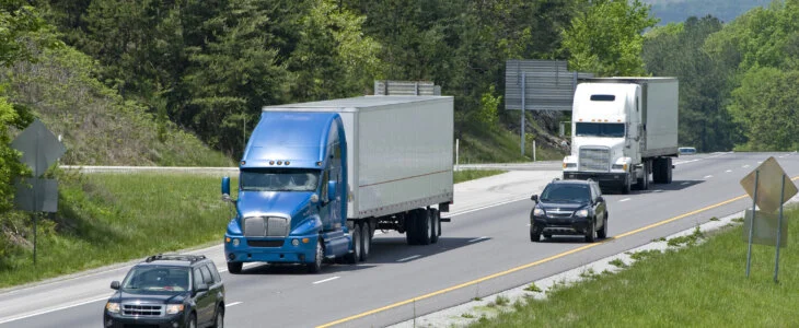 Semi trucks and cars on a highway