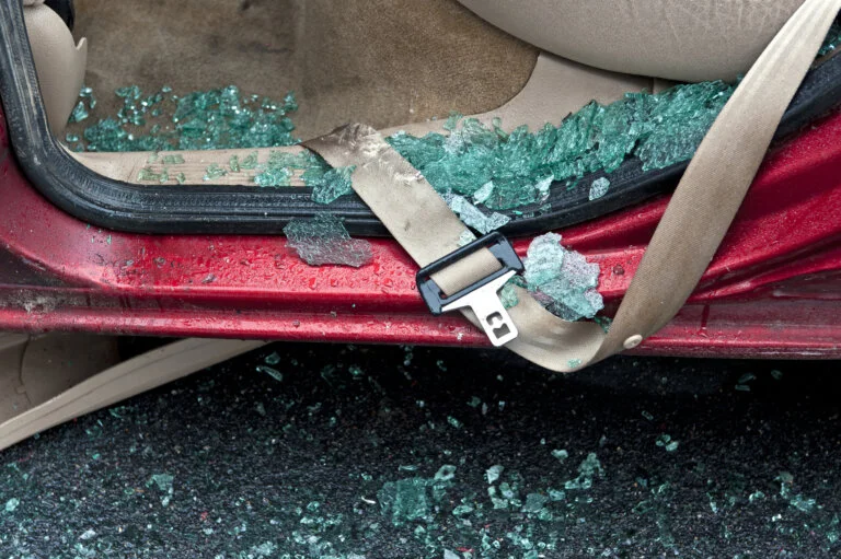 Close up of seatbelt with damaged webbing in door